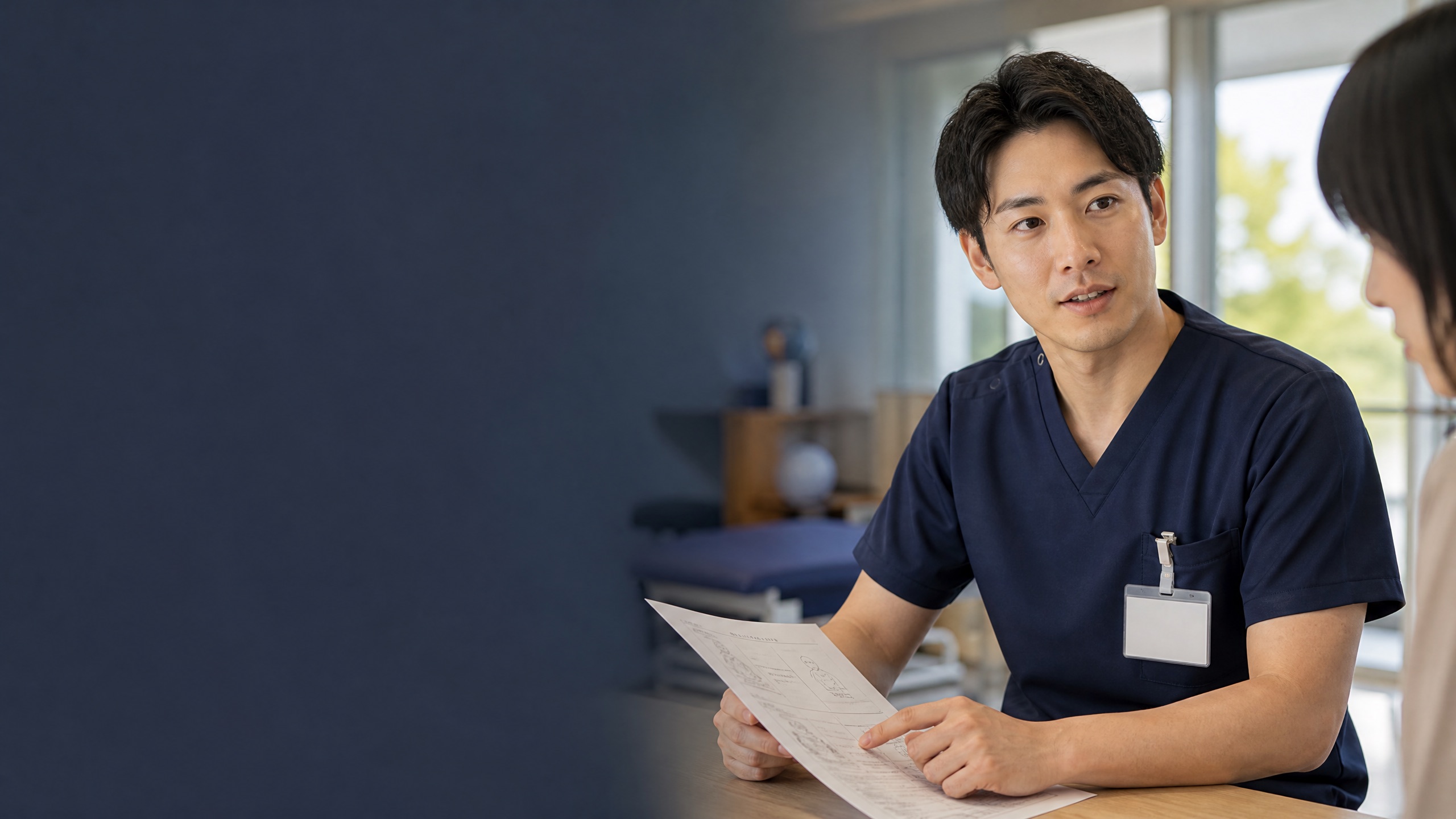 リハビリテーションの臨床現場で評価シートを確認する30代前半の日本人理学療法士